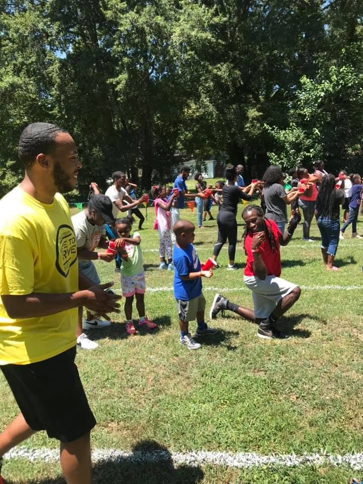 Children and adults enjoying an outdoor group activity